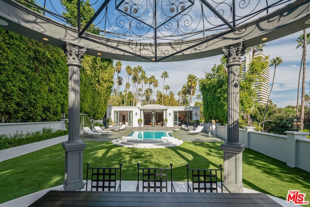 exterior space with a patio, a deck, and a lawn