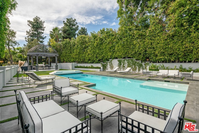 view of pool featuring a patio and a gazebo