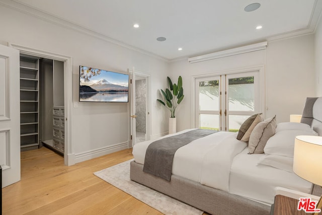 bedroom with light hardwood / wood-style floors and crown molding