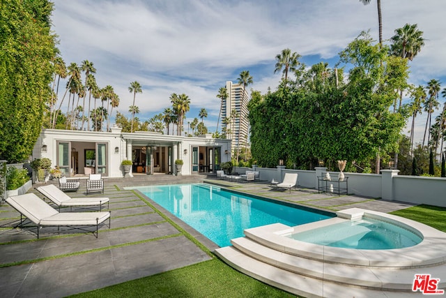 view of pool featuring an in ground hot tub and a patio area