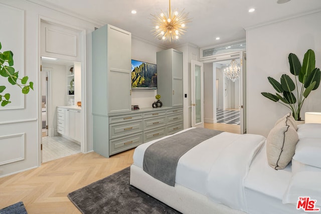 bedroom featuring ornamental molding, ensuite bathroom, an inviting chandelier, and light parquet floors