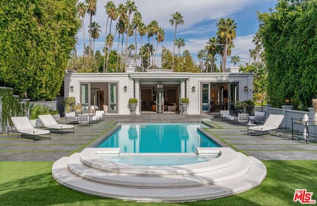 back of house featuring a patio and a yard