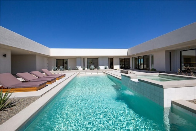 view of swimming pool with an in ground hot tub