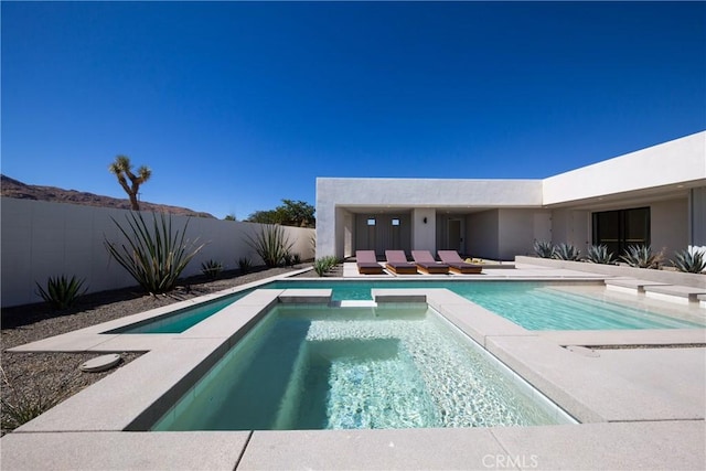 view of pool with an in ground hot tub