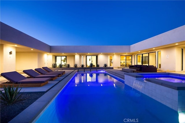 view of pool featuring an in ground hot tub, a patio, and an outdoor living space