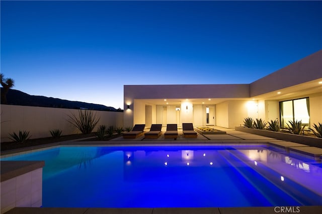 view of pool at dusk