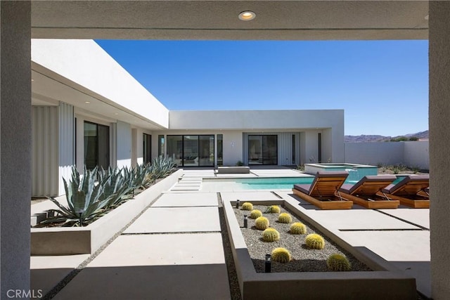 view of pool with a patio area and an in ground hot tub