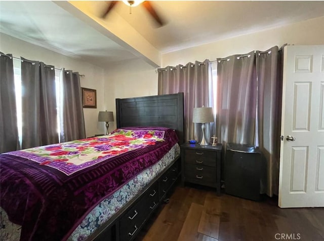 bedroom with dark hardwood / wood-style floors, ceiling fan, and multiple windows