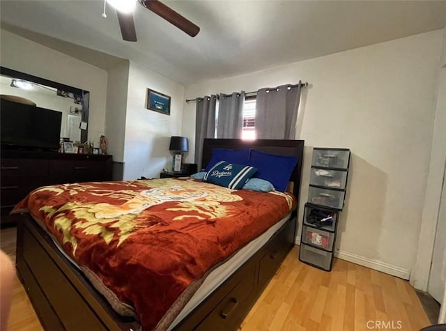 bedroom with ceiling fan and light hardwood / wood-style flooring