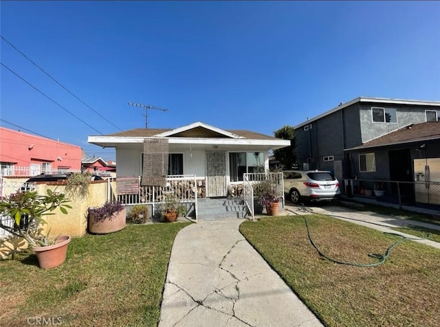 bungalow-style home with a porch and a front yard