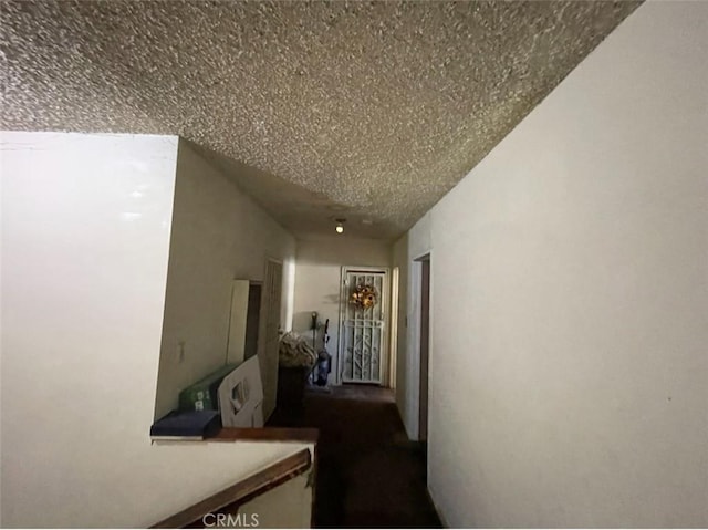 hallway with a textured ceiling