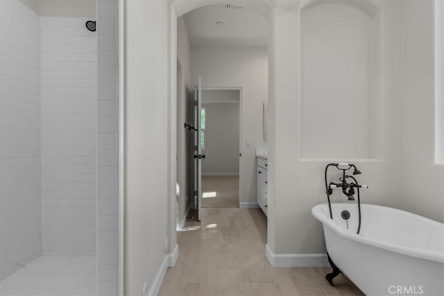 bathroom featuring vanity and independent shower and bath