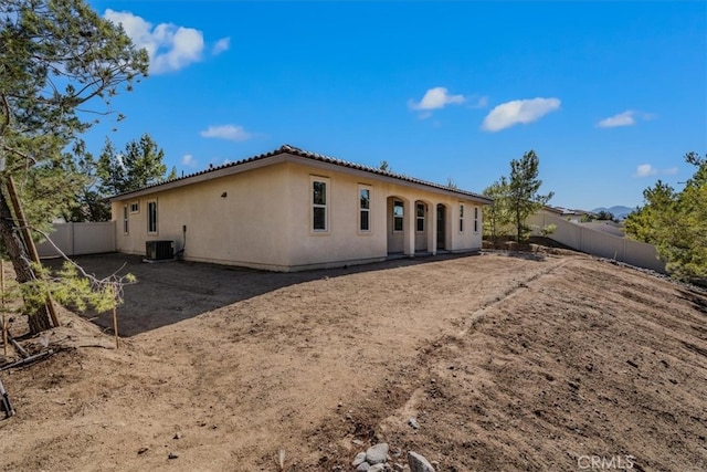 back of house featuring central air condition unit