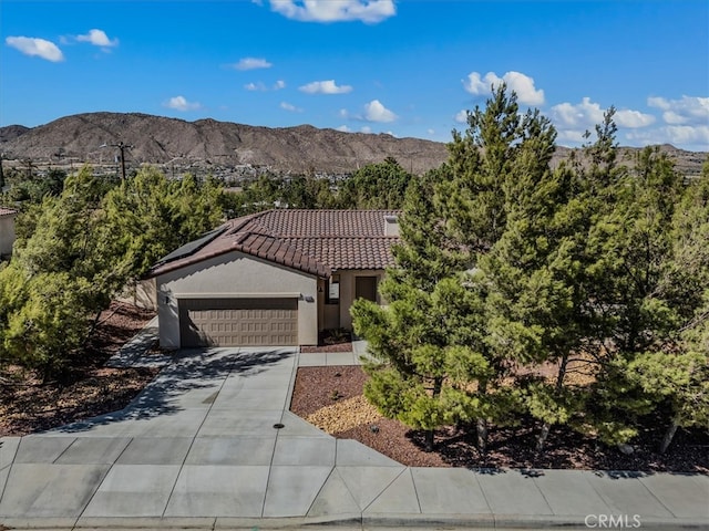 view of front of property with a mountain view and a garage