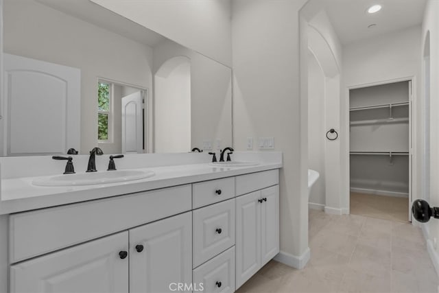 bathroom with vanity, a bathtub, and tile patterned flooring