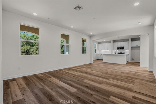 unfurnished living room featuring light hardwood / wood-style flooring