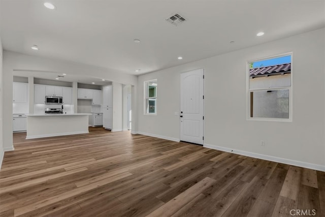 unfurnished living room featuring hardwood / wood-style flooring