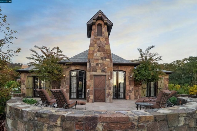 back of property featuring a patio and french doors