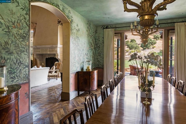 dining area with an inviting chandelier and dark parquet flooring