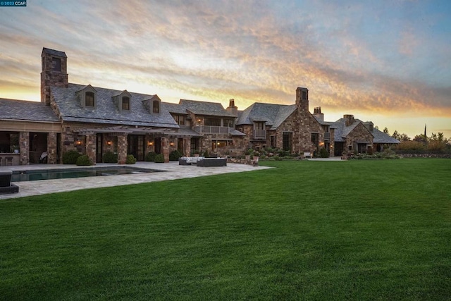 yard at dusk with outdoor lounge area and a patio area