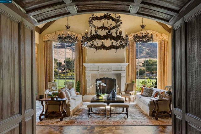 living room with lofted ceiling, a healthy amount of sunlight, and a notable chandelier