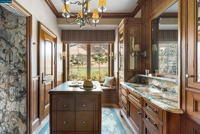 bathroom featuring crown molding, tile floors, dual sinks, oversized vanity, and an inviting chandelier