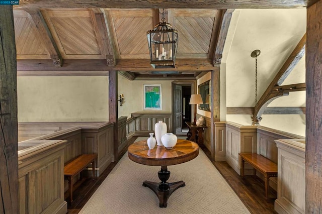 interior space featuring dark wood-type flooring, wood ceiling, and beamed ceiling