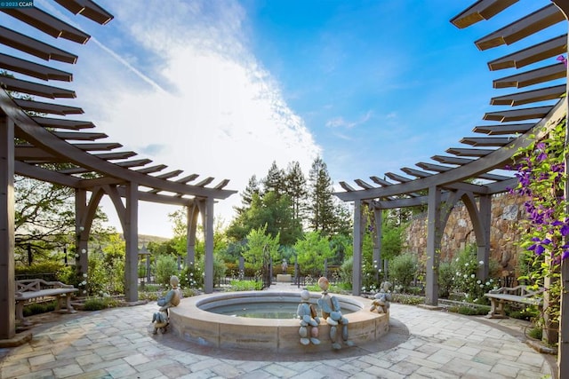 view of patio featuring a pergola and an in ground hot tub