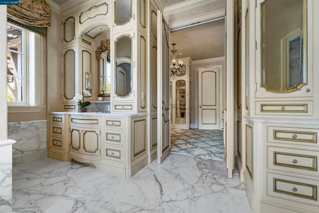 bathroom featuring an inviting chandelier, ornamental molding, and tile flooring