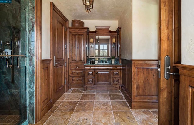 bathroom featuring vanity, tile floors, and a shower with shower door