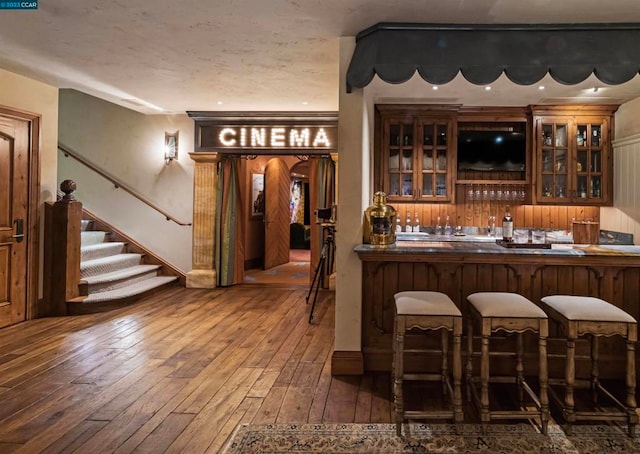 bar with dark hardwood / wood-style floors