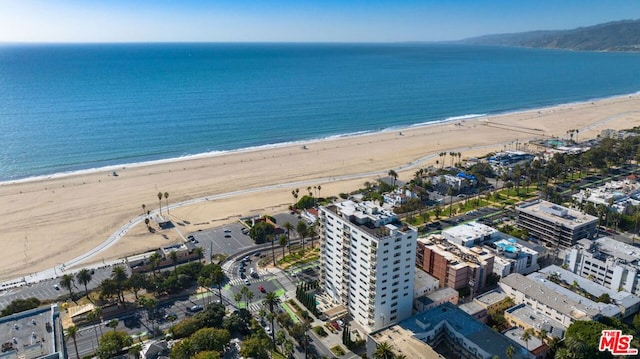 birds eye view of property with a water view and a view of the beach