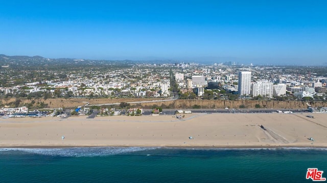 birds eye view of property with a beach view and a water view