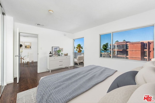 bedroom with dark hardwood / wood-style floors