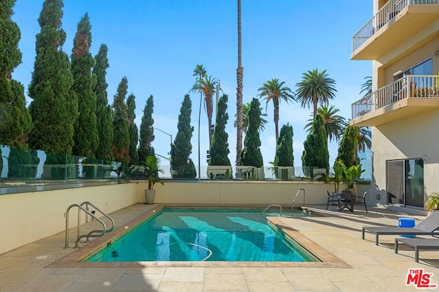 view of pool featuring a patio