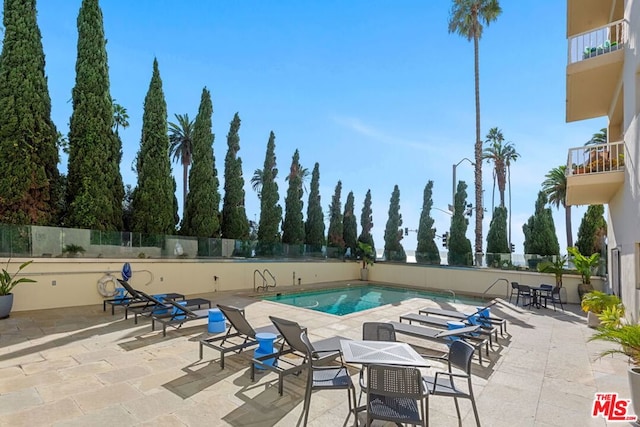 view of swimming pool featuring a patio area