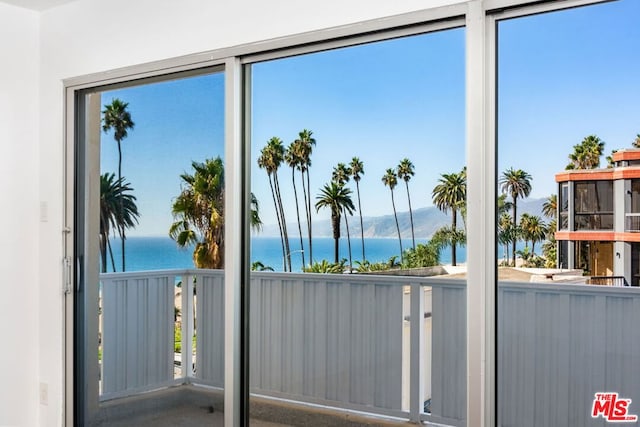 sunroom / solarium featuring a water view