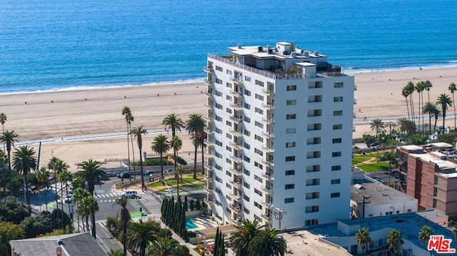 drone / aerial view featuring a beach view and a water view