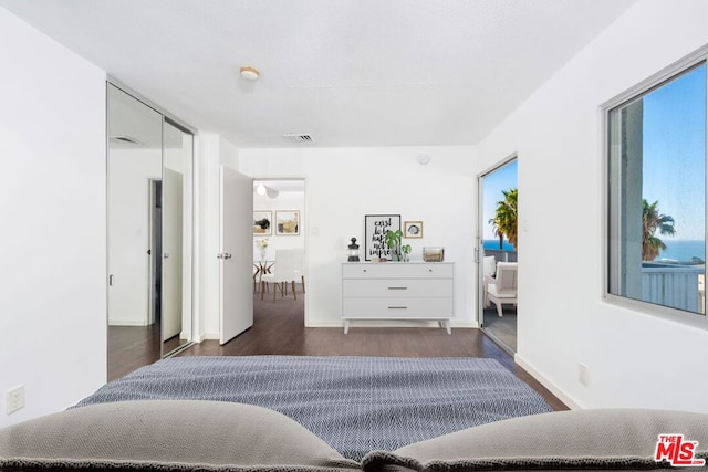 bedroom with dark hardwood / wood-style flooring