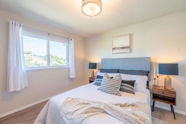 bedroom with wood-type flooring