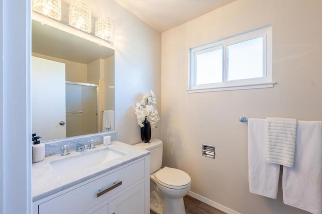 bathroom featuring toilet, wood-type flooring, and large vanity