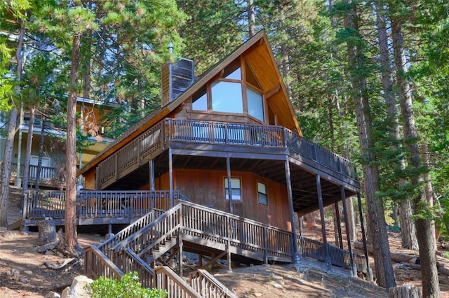 rear view of property with a wooden deck