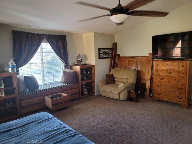 bedroom featuring ceiling fan and dark carpet