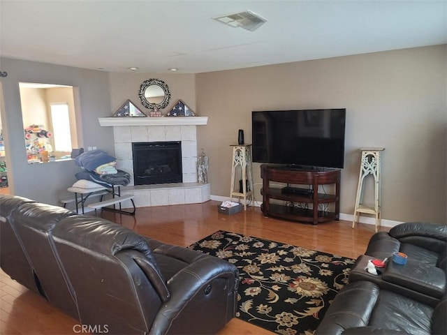 living room featuring a fireplace and hardwood / wood-style floors