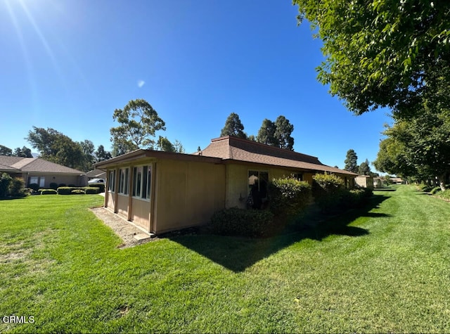 view of home's exterior with a yard