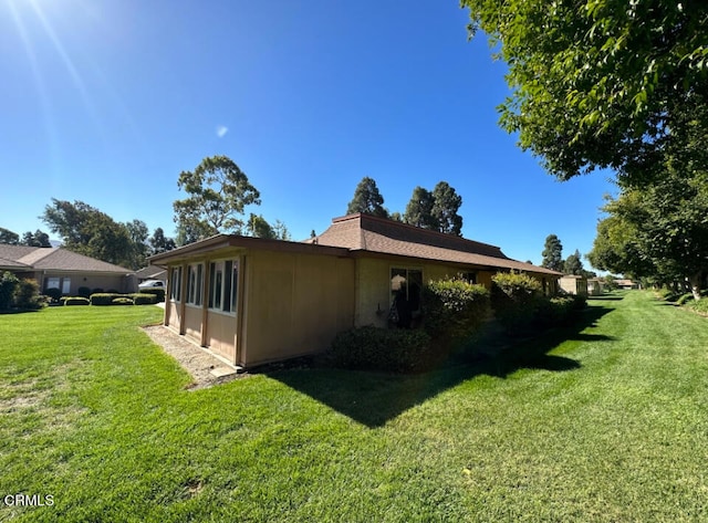 view of home's exterior with a lawn