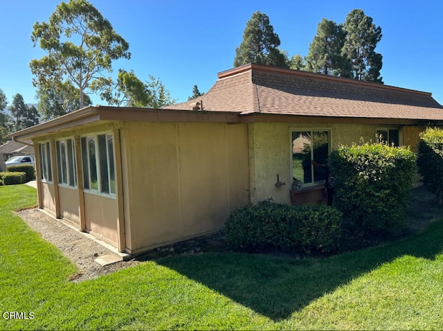 view of home's exterior with a lawn