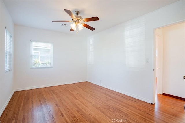 spare room featuring ceiling fan and light wood-type flooring