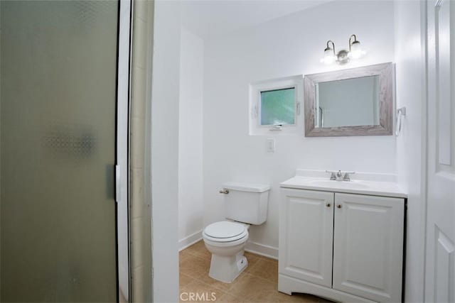 bathroom featuring tile patterned floors, vanity, an enclosed shower, and toilet