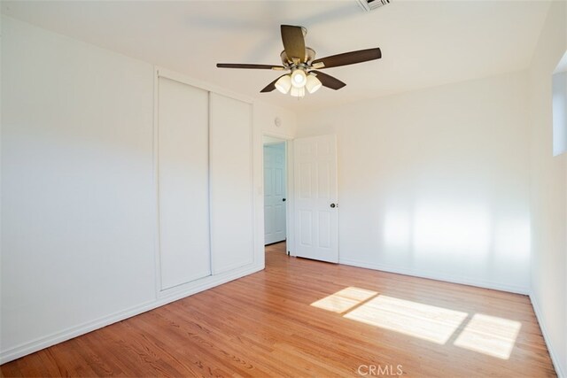 empty room featuring ceiling fan and hardwood / wood-style flooring